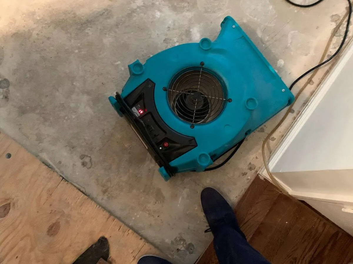 Air mover drying subfloor during Commercial Water Damage Restoration in Whitestown